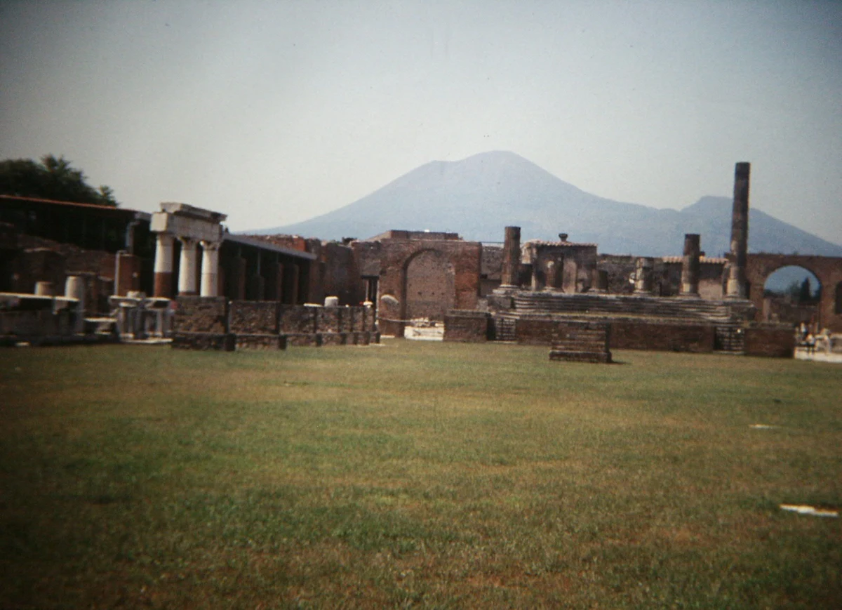 The Forum of Pompeii with columns and Mount Vesuvius rising behind