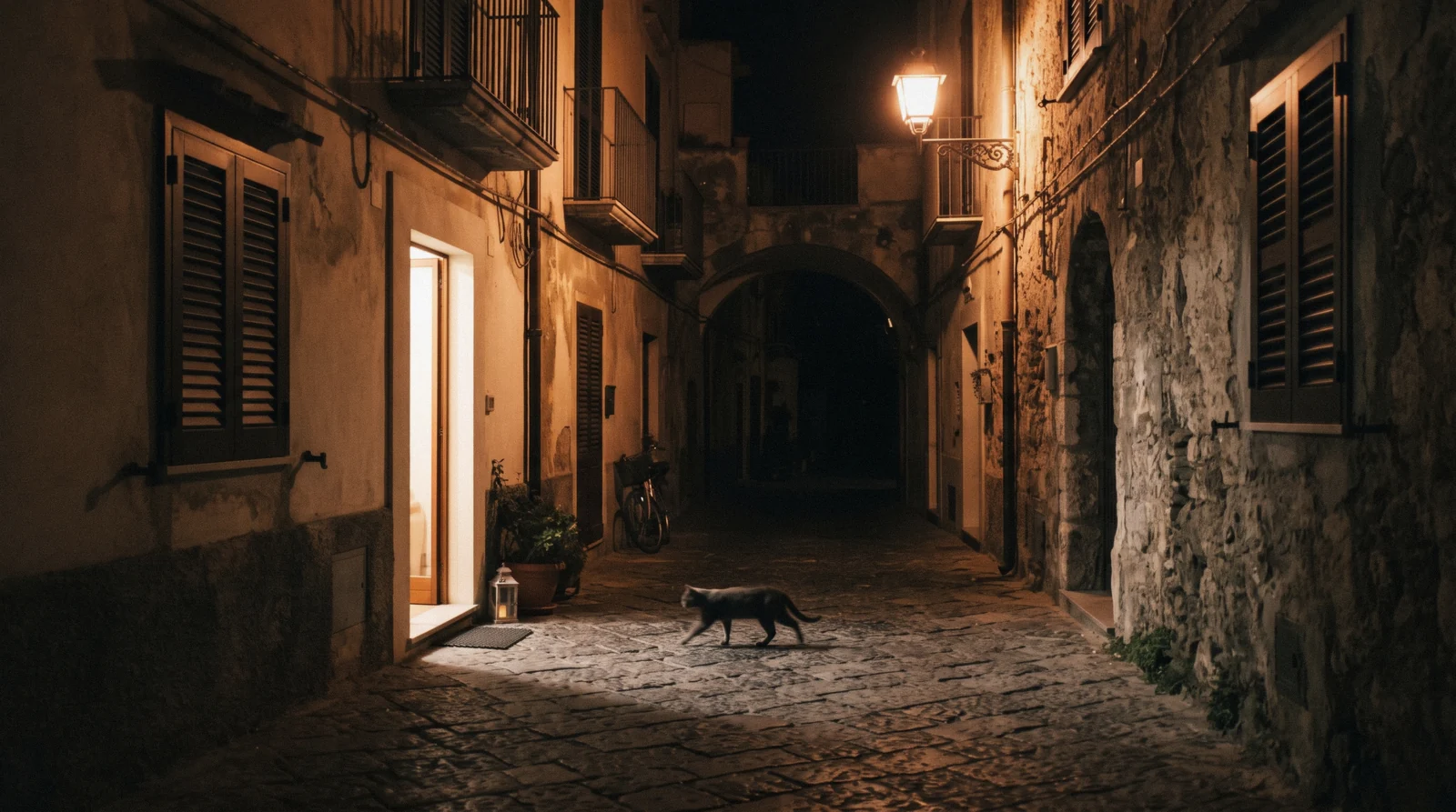 A quiet Sorrento side street in the early evening with warm light on the shutters and one passer-by