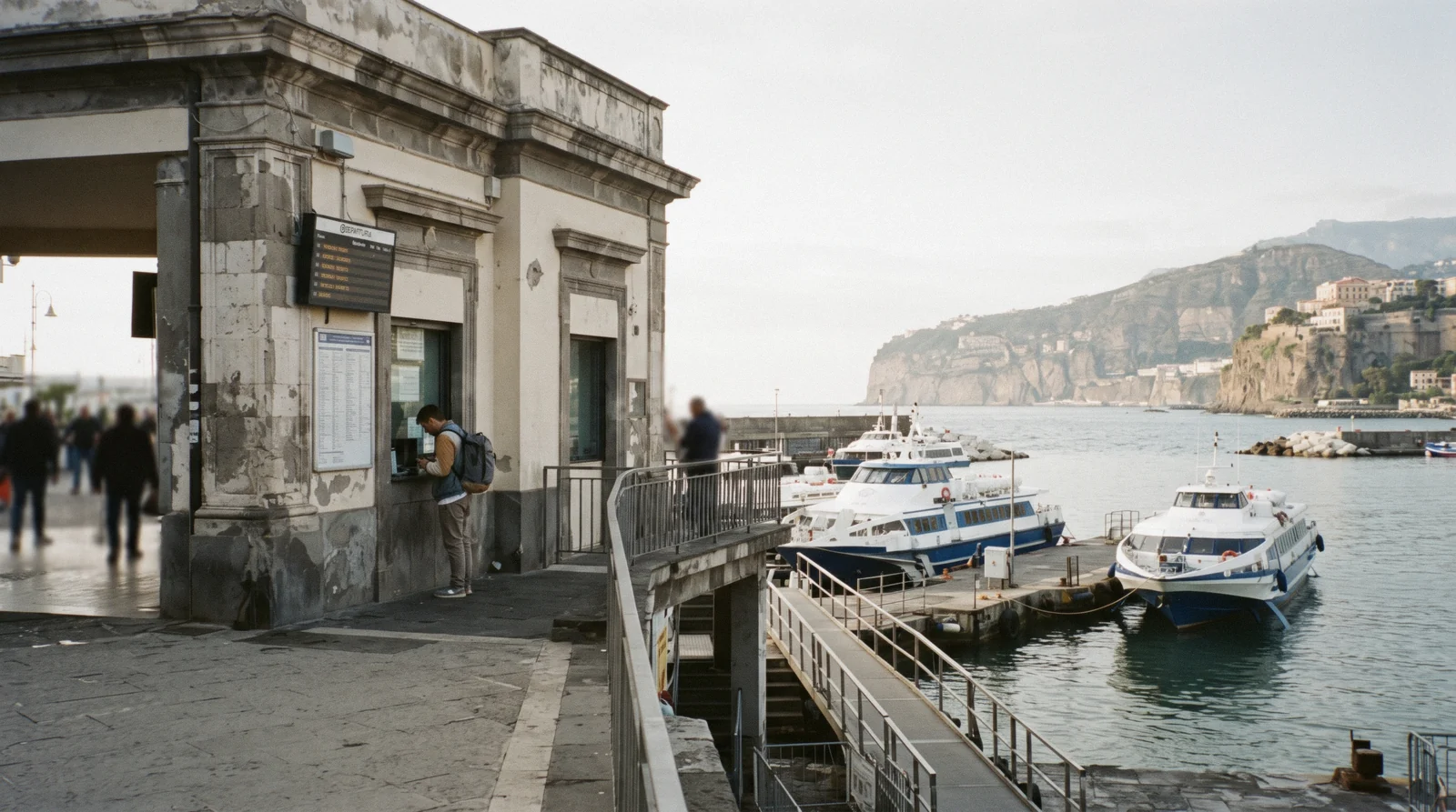 The NLG ticket office at Marina Piccola in Sorrento in early morning light with hydrofoils tied below
